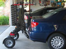Side view of installed Bruno Chariot wheelchair and scooter lift and vehicle parked in garage.